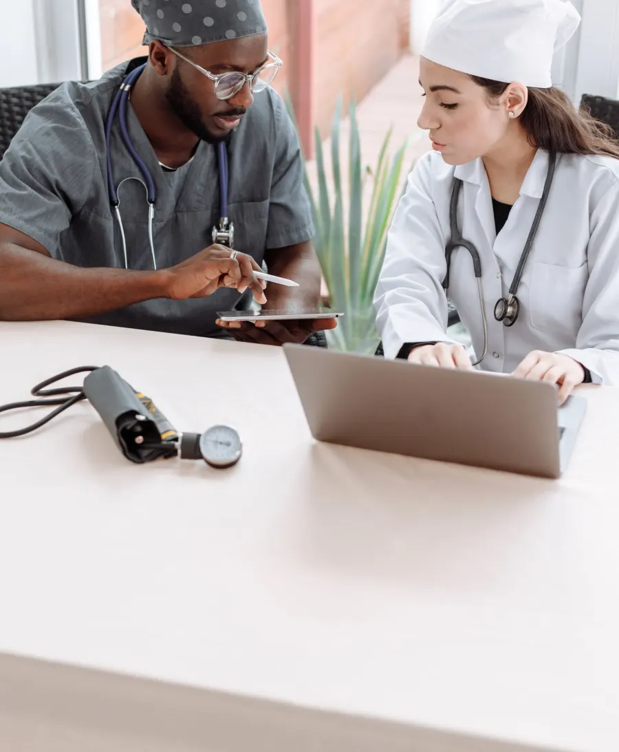 Medical professionals reviewing a tablet